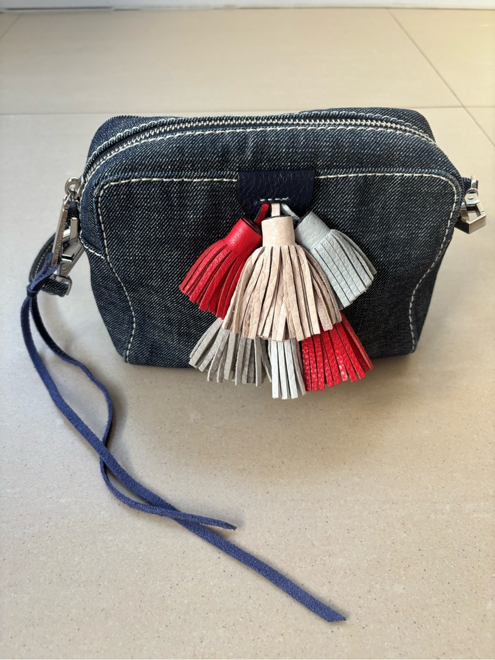 REBECCA MINKOFF Sofia Denim Crossbody Wristlet with Red and Neutral Tassels